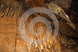 Close-up of clay stalactites in an underground cave. Speleological research and study of caves