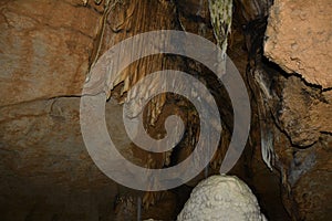 Close-up of clay stalactites in an underground cave. Speleological research and study of caves