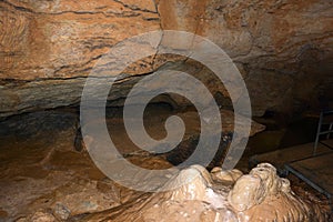 Close-up of clay stalagmites rising from the floor of an underground cave. Speleological research and study of caves