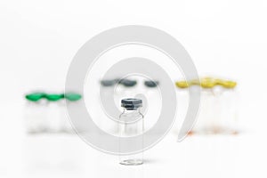 Close-up of clean and empty medical vials with caps isolated on white background.