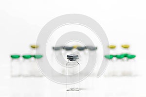 Close-up of clean and empty medical vials with caps isolated on white background.