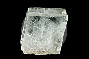 Close-up of clear calcite crystal on black background.