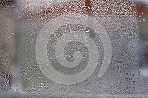 Close-up clear drops of water on window glass surface