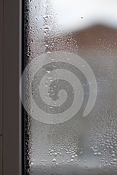 Close-up clear drops of water on window glass surface