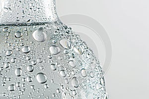 Close-up of a clear water bottle, adorned with refreshing droplets, showcasing purity.