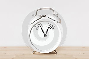 close-up clock alarm clock. transition from 2023 to 2024