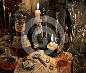 Close up with clock, key, candle, bottles and magic objects
