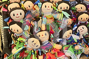 Close-up of cloth dolls for sale with smiley faces