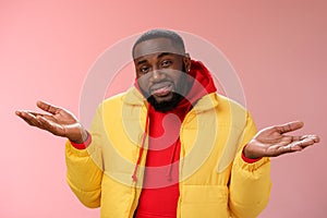 Close-up clueless unaware handsome stylish african-american bearded man in yellow jacket shrugging hands spread sideways