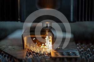 Close up cnc lasercutting of sparks fly out machine head for metal processing at the factory. Au