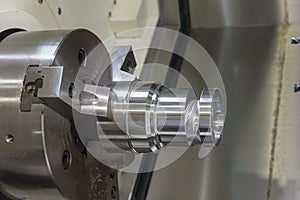 Close up of the CNC lathe jaw clamping raw material steel rod .