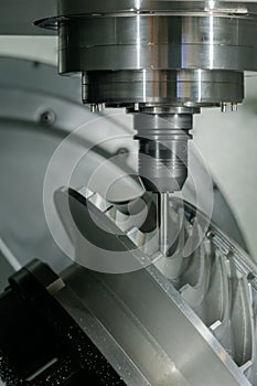 Close up: cnc turning milling machine cutting metal workpiece at factory
