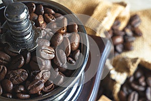 Close up coffee beans in vintage wooden mill-grinder