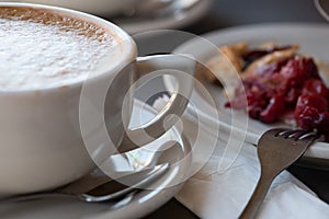 Coffee and cherry pie on a plate