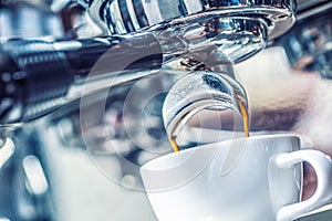 Close-up coffee machine pouring hot espresso.