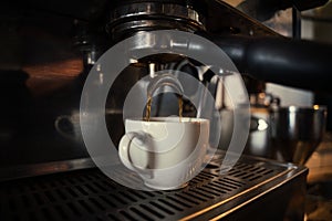 Close up of coffee machine producing espressos for customers in funky cafe