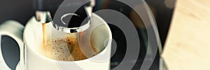 Close up of coffee maker machine pouring brewed hot Espresso