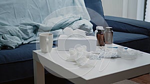 Close up of coffee table with medicine and bottle of pills