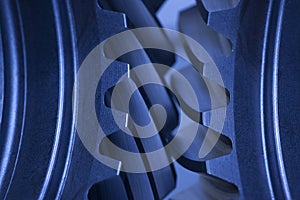 Close-up of cogwheels in an engine - dark blue colour