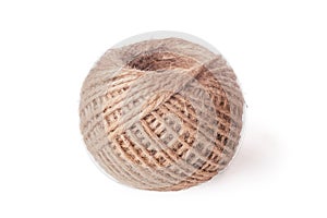 Close-up of coil ball of brown jute hemp natural rope twine on white background. Isolated. Textile, sewing, crocheting.