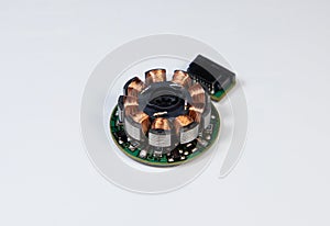 Close-up of the coil of an electric stepper motor on a white background