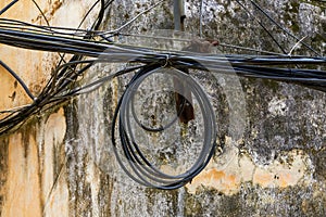 Close-up of a coil of outdoor electrical wiring in an old residential building