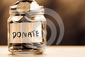 Close up Coins in glass jar for giving and donation concept