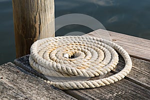 Close Up of a Colied Nautical Rope on a Wooden Pier