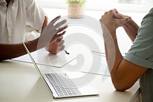 Close up of colleagues gesturing talking at business meeting