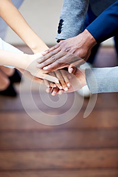 Close up of colleagues' hands clasped together