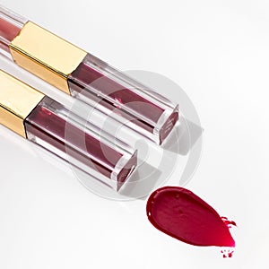 Close-up of a collection of colorful lipstick samples on a white background