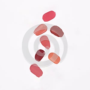 Close-up of a collection of colorful lipstick samples on a white background