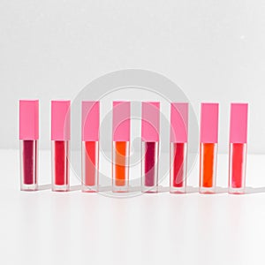 Close-up of a collection of colorful lipstick samples on a white background