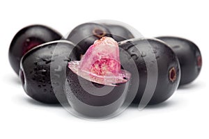 Close-Up of collection of Indian Ayurvedic medicinal fresh or fruit jamun Syzygium Cumini or black plum, with peeled seed