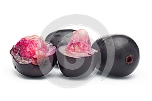 Close-Up of collection of Indian Ayurvedic medicinal fresh fruit jamun Syzygium Cumini or black plum, with peeled seed , half