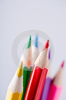 Close up of color pencils with different color over light background