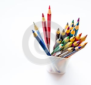 Close-Up color pencils in a plastic glass on background