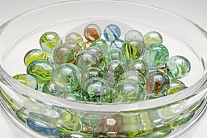 Close-up of colored glass marbles in a glass jar