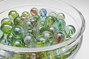 Close-up of colored glass marbles in a glass jar