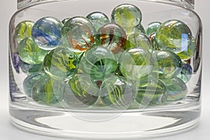 Close-up of colored glass marbles in a glass jar