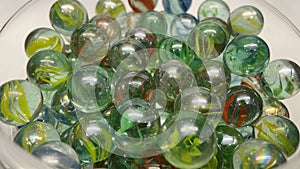 Close-up of colored glass marbles in a glass jar