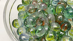 Close-up of colored glass marbles in a glass jar