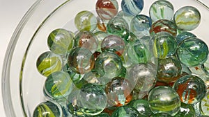 Close-up of colored glass marbles in a glass jar