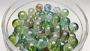 Close-up of colored glass marbles in a glass jar