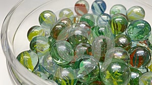 Close-up of colored glass marbles in a glass jar