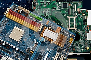 Close up of colored heap of electronic, plastic and metal parts from old discarded or obsolete PC components. Ecological