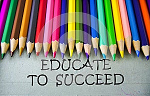 Close up colored pencil writing with EDUCATE TO SUCCEED .Education concept