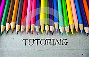 Close up colored pencil writing with TUTORING.Education concept