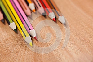 Close-up of colored pencils arranged in a wave pattern