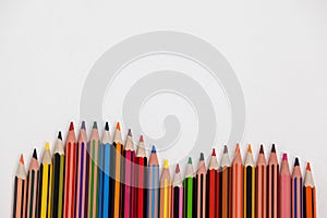 Close-up of colored pencils arranged in a wave pattern